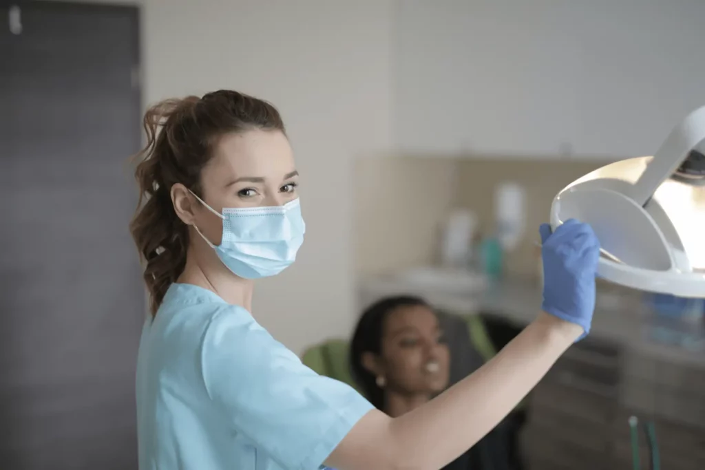 dental assistant with mask scrubs and gloves