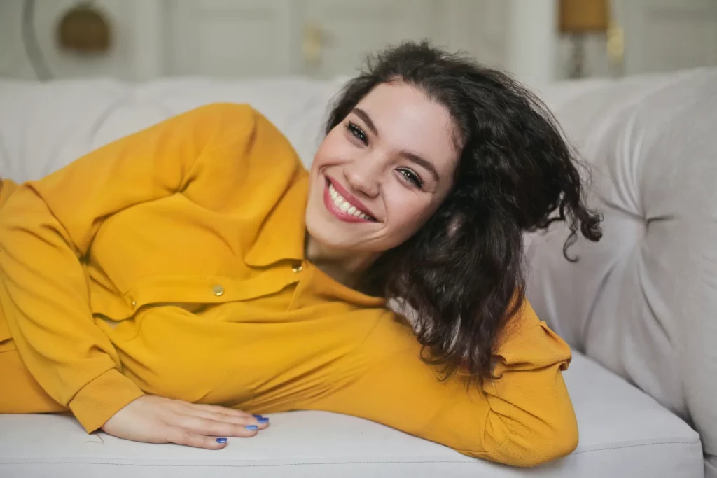 woman lying on couch smiling