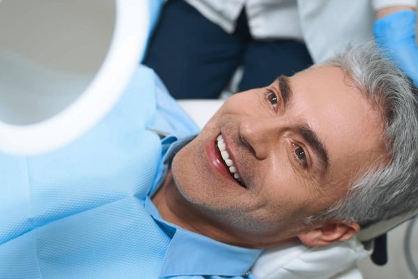 Happy man after dental implant procedure