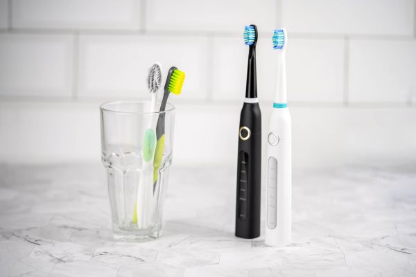Electric and regular toothbrush in a bathroom. Dental care.