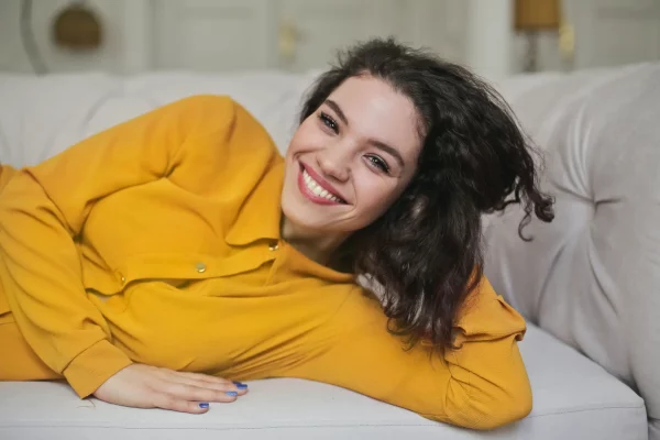 woman lying on couch smiling